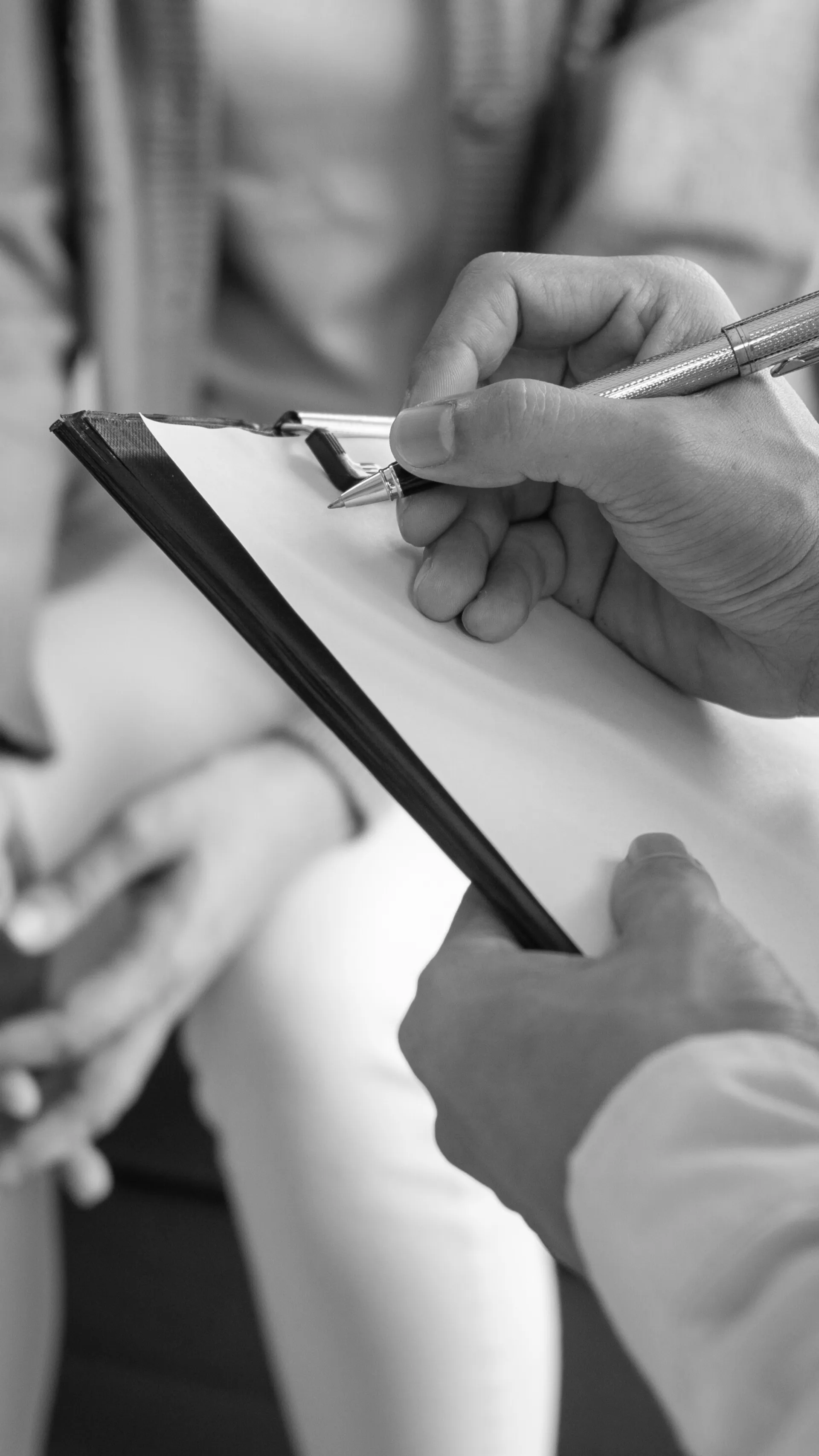 Hand writing on a clipboard