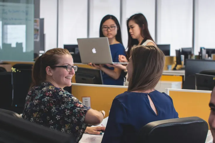 Photo of students working in a library