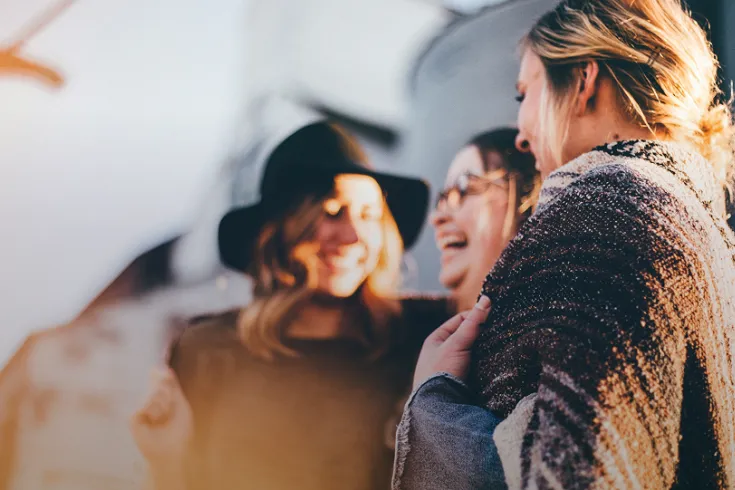 Photo of three women laughing together