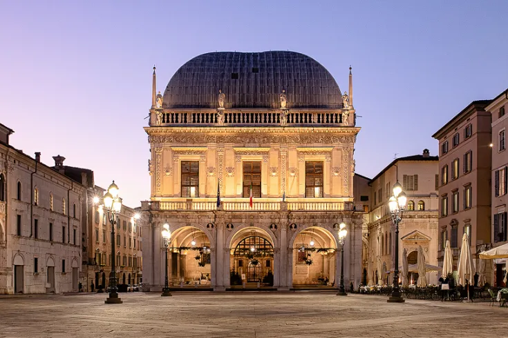 A beautifully lit Italian piazza in the evening