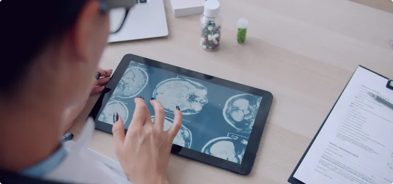 A view over a students shoulder looking at a tablet