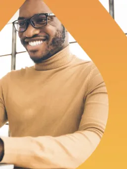 Man typing under a Drupal logo