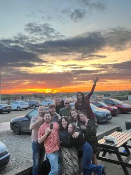 Our team in front of a sunset