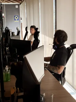 Two developers laughing at their desk in an office