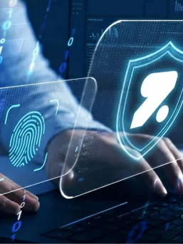 A person typing at a futuristic keyboard and screen