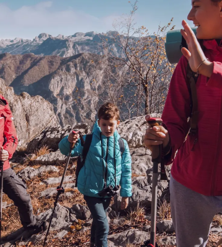 Three people in climbing gear on a mountain top