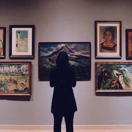 Person inside a museum looking at art