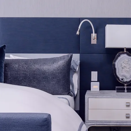 Luxury hotel bed and bedside table in a hotel room