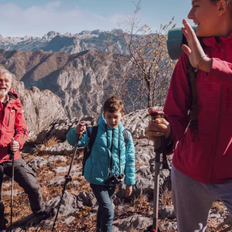 Three people in climbing gear on a mountain top