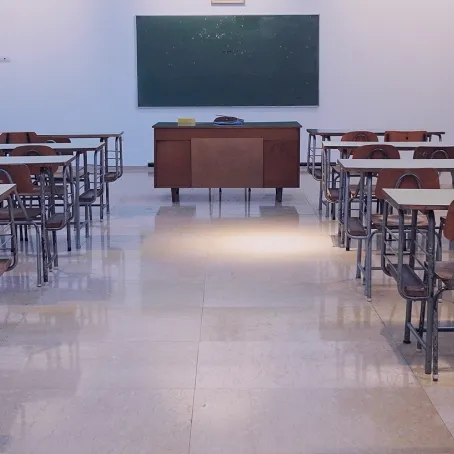 Image of a classroom with a blackboard at the end of the room