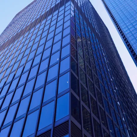A view of skyscrapers looking up from the ground towards the sky