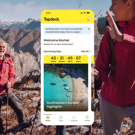 Topdeck Travel mobile page view on background of people on a mountain