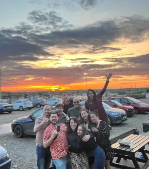 Our team in front of a sunset