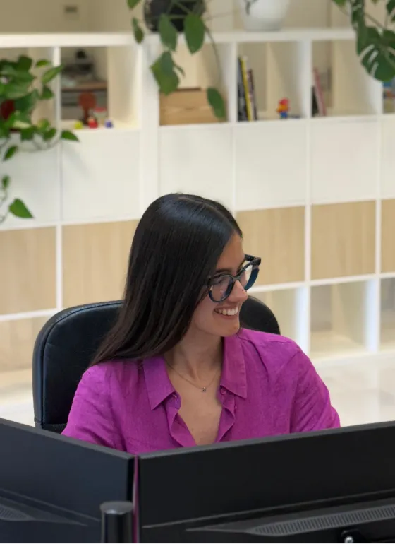 Alba working in a pink shirt