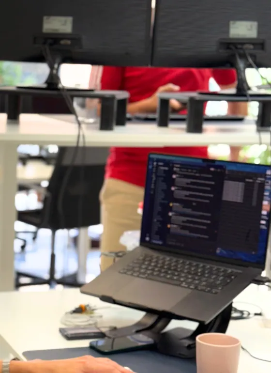 Laptop, monitors and hands