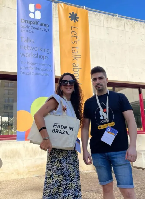Pau and antonio standing in front of the DrupalCamp Spain building