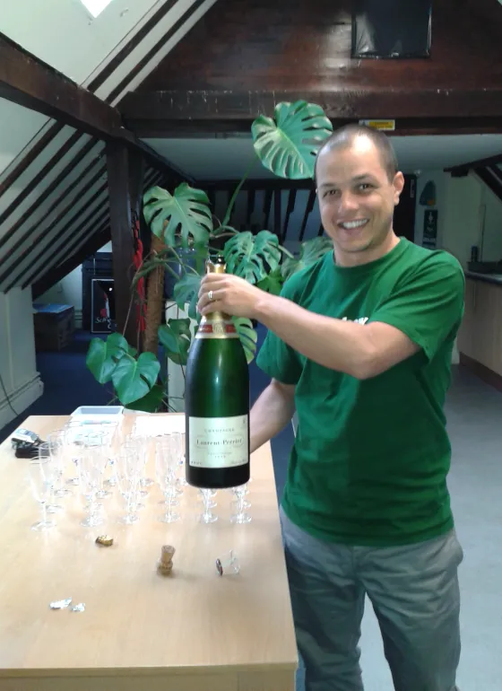 Rod celebrating with a bottle of champagne 
