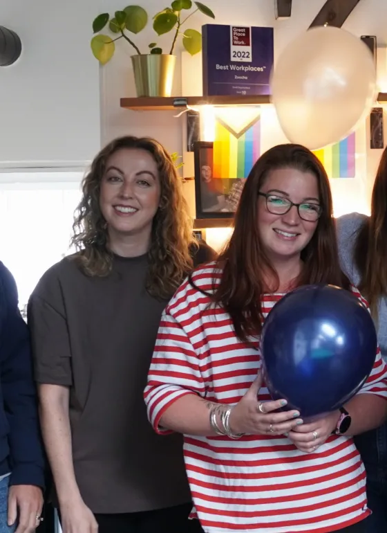 Our team holding balloons at Zoochas birthday