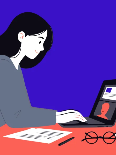 Person working at a laptop during an online meeting