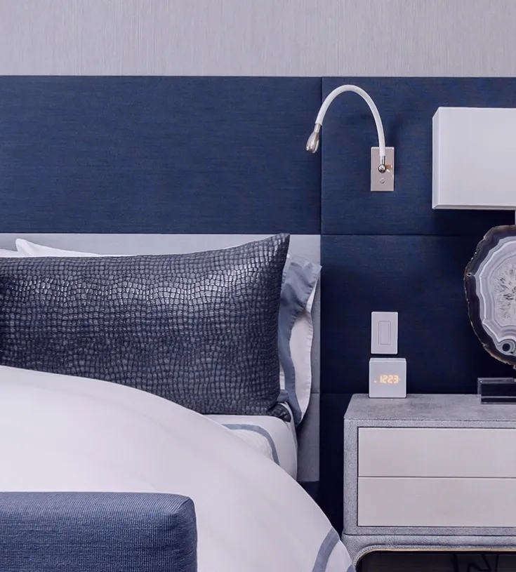 Luxury hotel bed and bedside table in a hotel room