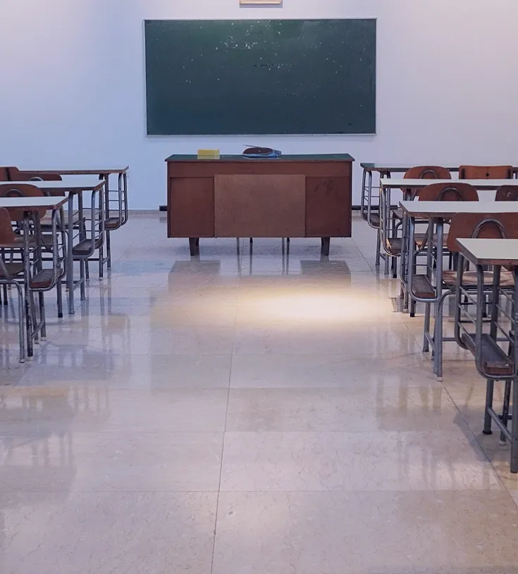 Image of a classroom with a blackboard at the end of the room