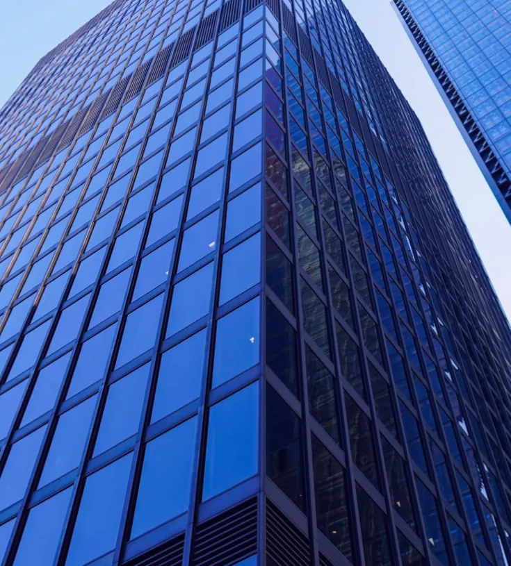 A view of skyscrapers looking up from the ground towards the sky
