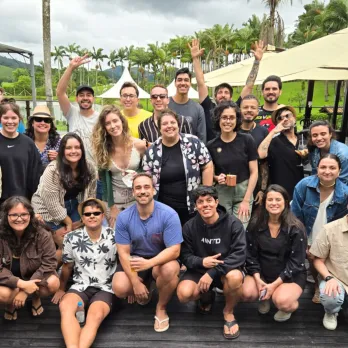Our Brazil team outside all posing by a pool