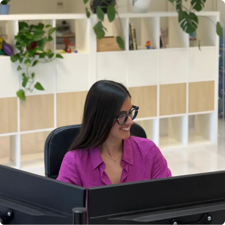 Alba working in a pink shirt